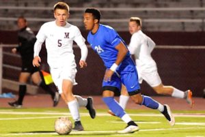 Paul Quildies defends Christopher Nkoghe during play. Both players scored goals in the Mustangs 2-1 win over the Chargers